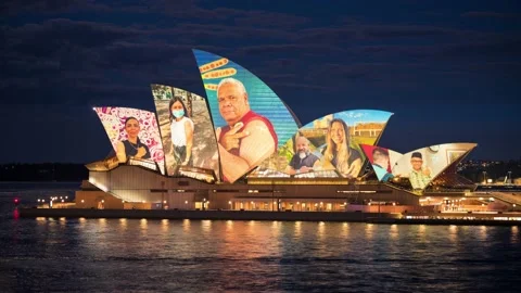 TIme lapse of Opera House from Circular Quay at dusk with image display show Stock Footage 163254342