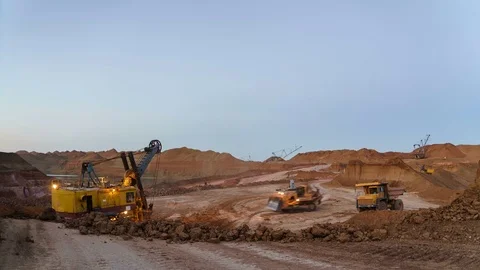 Time lapse of operating mine at suset. Excavators load ore into dump-trucks Stock Footage 75407092