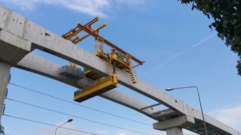 Time lapse. An orange overhead crane is moving towards a bridge pier Stock Footage 165578102