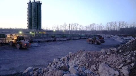 Time lapse of ore storage. Tiltdozers load ore into gondola cars Stock Footage 75289713