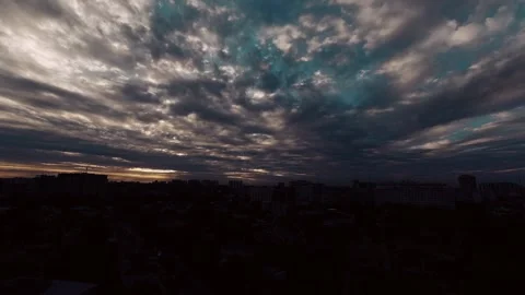 Time lapse over the city during sunset, beautiful clouds, the sun breaks through Stock Footage 143211480