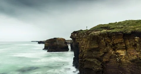 Time lapse over landscape, drifting clouds, water and rocks. 스톡 동영상 77916829