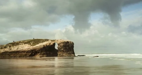 Time lapse over shore line, drifting clouds, water and rocks. Stock Footage 77917575