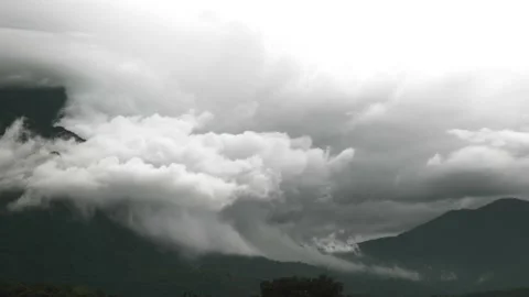 Time lapse overcast cloudy fast moving and swirling on sky and mountainous Stock Footage 198799535