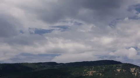 Time Lapse-Pan-Clouds rolling and passing over mountain Stock Footage 65743649