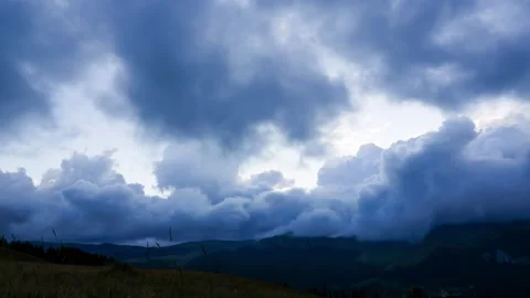 Time lapse with pan motion of storm clouds in mountain environment at sunset Stock Footage 247471842