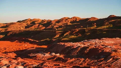 Time lapse PAN of operating mine covering with a shadow at suset. Excavators Stock-Footage 75407942