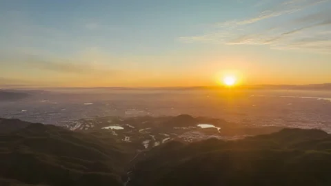 Time Lapse: Pan over sprawling city as sun rises over horizon and clouds move in Stock Footage 231188355