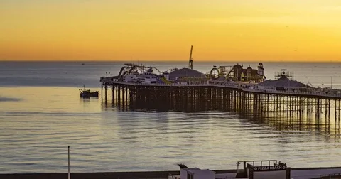 Time lapse panning view of a sunset on the beach in Brighton Stock Footage 70194542