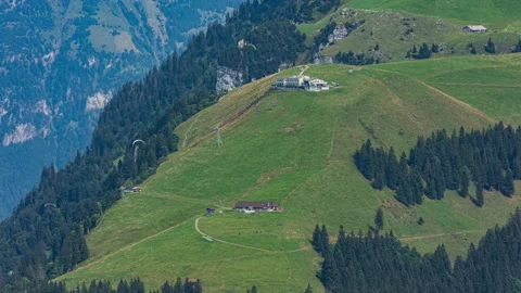 Time lapse, paragliders flying over the mountains. Emmetten-Niederbauen cab.. Stock Footage 306108016