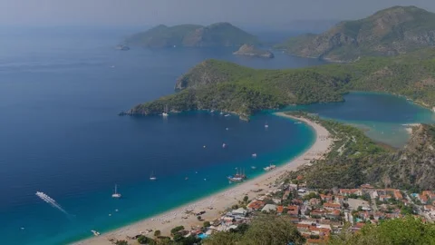 Time lapse: paragliders gliding fast and boats crossing Oludeniz Blue Lagoon Stock Footage 304006327