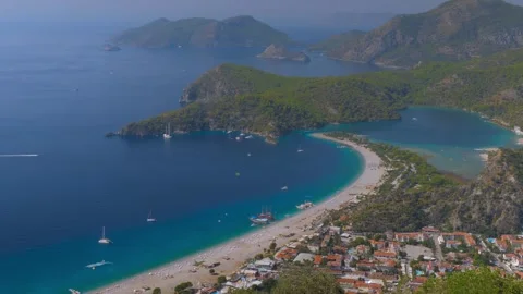 Time lapse: paragliders gliding fast and boats crossing Oludeniz Blue Lagoon Stock Footage 304006680
