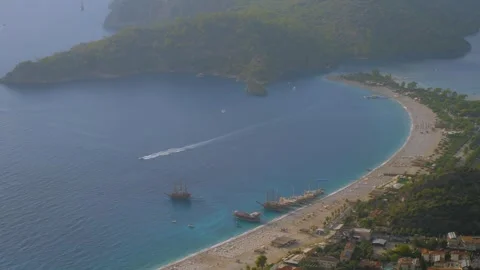 Time lapse: paragliders gliding fast and boats crossing Oludeniz Blue Lagoon Stock Footage 319047347