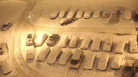 Time lapse of the parking after a snowfall. Cars barely passing through the snow Stock Footage 66575625