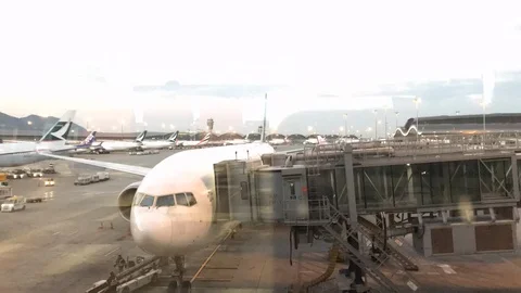 Time lapse of a passenger overpass working with an aircraft at a airport Stock Footage 113548216