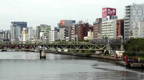 Time Lapse of Passenger Train Passing the Tokyo Skyline Daytime - Tokyo Japan Stock Footage 46455977