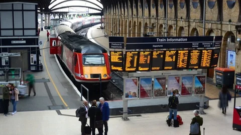 Time lapse passengers boarding train by departure and arrivals board at station Stock Footage 103378859