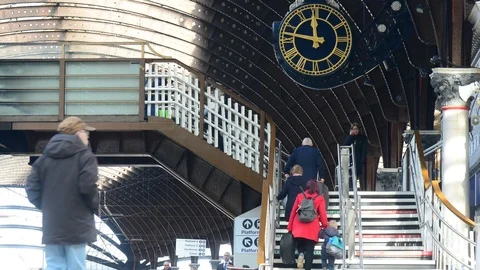 Time lapse passengers using footbridge by giant clock at york railway station uk Stock Footage 103251280