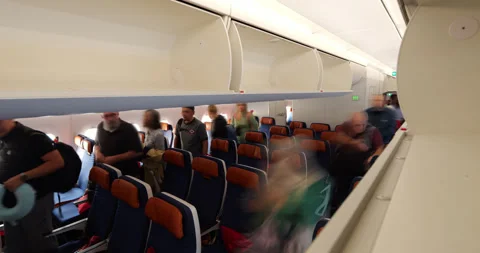 Time lapse, passengers walk to exit at economy class cabin of airliner Stock Footage 318701617