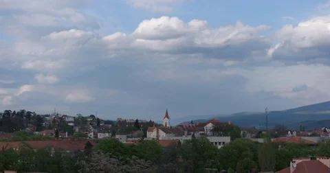 Time Lapse of Passing Clouds Over the Small City at Sunny Day Stock Footage 74560732