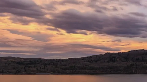 Time lapse pastel colored sunset clouds over lake Stock Footage 72658483