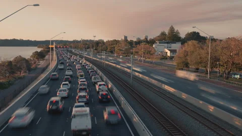 Time lapse of peak hour traffic heading into city - early evening beside river Stock-Footage 139502079