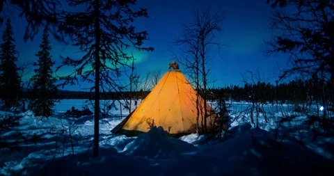 Time Lapse of People Going in and Out of a Lit Up Teepee at Night Stock Footage 113992346