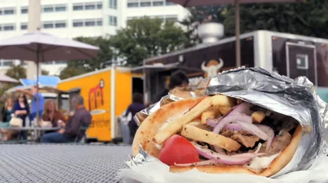 Time lapse of people ordering eating from food truck trucks pita sandwich table Stock Footage 42529779