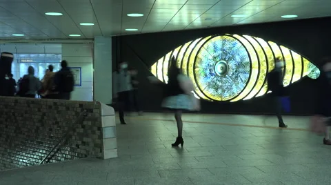 Time lapse of people passing by a moving art piece in Shinjuku Tokyo Stock Footage 57379361