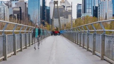 Time lapse people walking across a bridge with downtown city in background Stock Footage 73580775