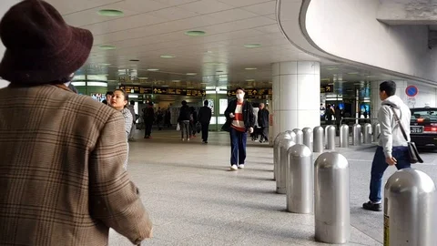 A time lapse of people walking to and from Shinjuku station Stock Footage 104851300