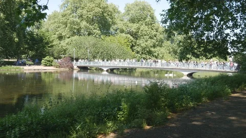Time lapse. People walking on a bridge over a lake. Stock Footage 107476427