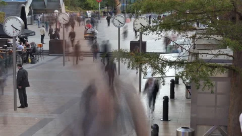 Time lapse. People walking on a busy square with clocks. Stock Footage 96129797