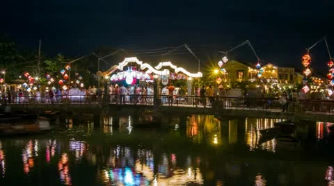 Time Lapse of People walking over brightly lit Hoi An Bridge in Vietnam Stock Footage 11359185