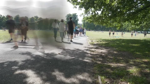 Time lapse. People walking on a sidewalk in a park. Stock Footage 137458165