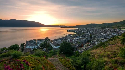 Time lapse photography of hillside ancient town lake surface sunset flowing Stock Footage 337923887