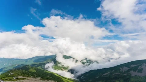 Time lapse photography of mountain fluffy sea of clouds layered peak ridge clear Stock Footage 337925732