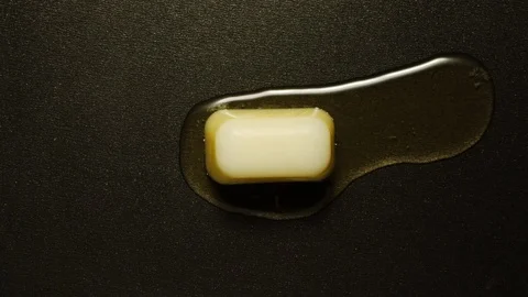 TIME-LAPSE: Piece of butter melts in hot frying pan - Top view Stock Footage 101044153