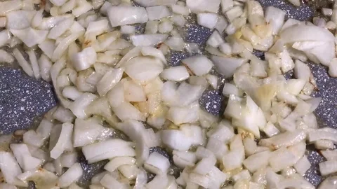 Time lapse of pieces of cutting white onions roasted with olive oil in a pot. Stock-Footage 85718170