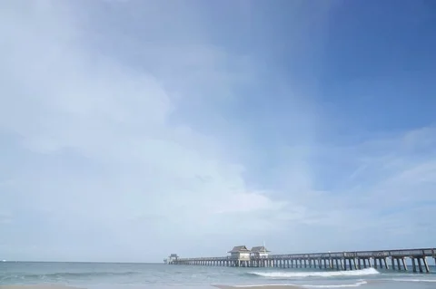 Time Lapse of Pier in Ocean &amp; Clouds Stock Footage 76929764