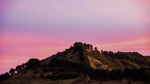 Time lapse pink clouds moving behind the mountain Stock Footage 125131774
