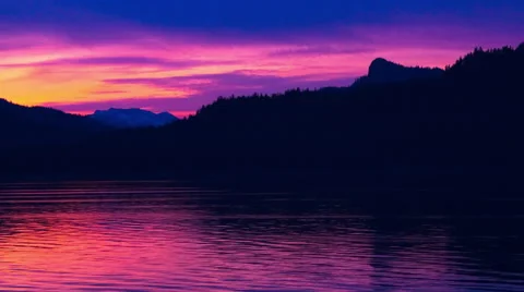 Time lapse of a pink sunset behind the silhouette of mountain ridge in the Stock Footage 52217439