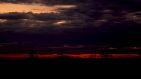 Time lapse of a pink sunset going dark from the field Stock Footage 229481874