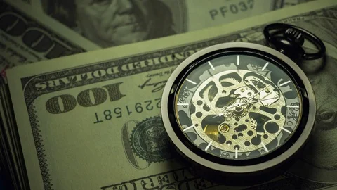 Time lapse pocket watch on dollar banknote stacking in darkness. Stock Footage 113594359