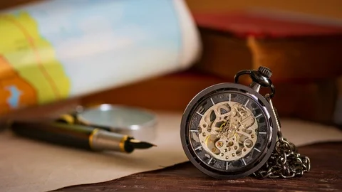 Time lapse pocket watch with old books and paper map on the table. Stock Footage 122145148