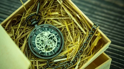 Time lapse Pocket watch winder on natural wheat straw in a wooden box. Stock Footage 105690543