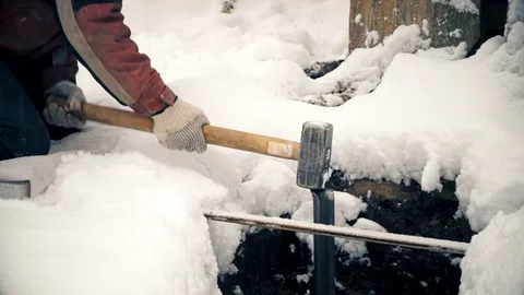 Time lapse of pounding an iron angle bar into earth with sledge hammer Stock Footage 71140416