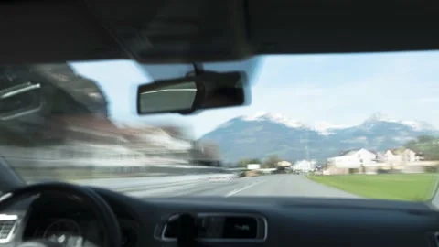 Time Lapse POV inside passenger seat of a car driving through Swiss roads Stock Footage 182760838