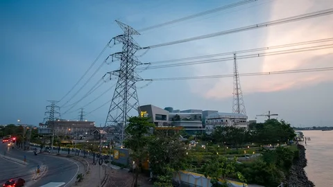 Time lapse Power Plant Engineering and high voltage pole near river and road Stock Footage 107678744