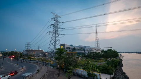 Time lapse Power Plant Engineering and high voltage pole near river and road Stock Footage 107678751